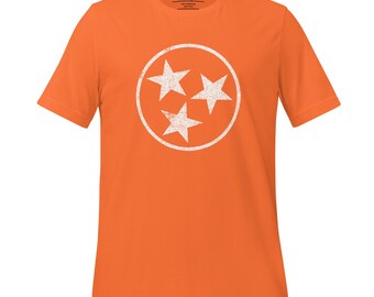 Könnte beinhalten: Orangefarbenes T-Shirt mit einem weißen, abgenutzten Kreis, der drei weiße Sterne enthält, die den Bundesstaat Tennessee repräsentieren.