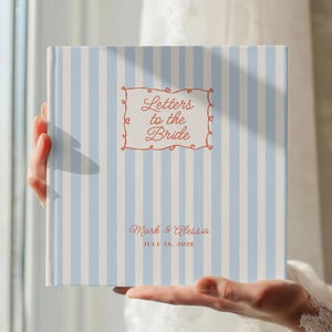 May include: A white ceramic mug with a black handle and the text "But First, Coffee" in a bold, black font. The mug is set against a neutral background, highlighting its simple design.