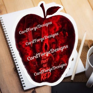 May include: A die-cut sticker shaped like an apple with a dark red and black graphic design. The artwork features two faces, a knife, a silhouette of a person, and the text "I'LL PAINT THE TOWN RED" overlaid with a repeating "CardForgeDesigns" watermark.