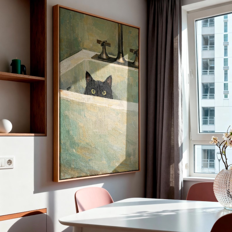 May include: A framed painting of a black cat in a bathtub, with a vintage aesthetic. The artwork uses a green and white colour palette. The painting is mounted on a light-coloured wall in a room with a window and a table.