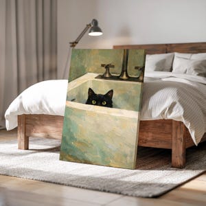 May include: A canvas print depicting a black cat in a bathtub, rendered in a vintage style. The artwork uses a muted colour palette of greens and creams, with the cat's bright yellow eyes as a focal point. The taps are visible.