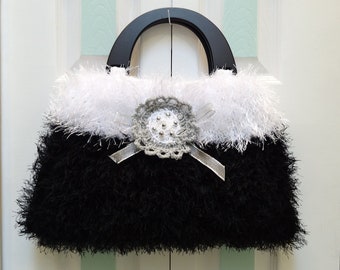 HANDKNITTED HANDBAG/PURSE :Sale item,  Black and White, fun fur, large,, black wooden  handles and a silver beaded applique