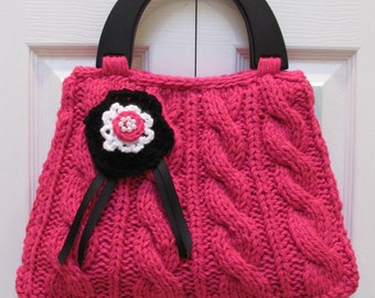 HANDKNITTED HANDBAG/PURSE,  Hot pink/raspberry yarn, Designer style, black wood handles and a crocheted flower