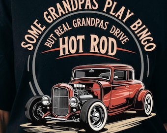 May include: Black t-shirt featuring a red hot rod graphic with the text "SOME GRANDPAS PLAY BINGO BUT REAL GRANDPAS DRIVE HOT ROD". The design includes a vintage car illustration and a circular text design.