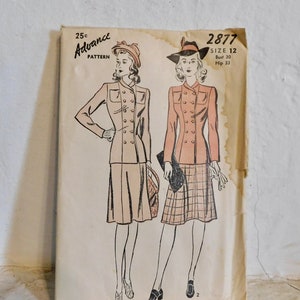 May include: Vintage sewing pattern for a women's dress, Advance Pattern 2877, size 12, bust 30, hip 33. The pattern shows two women wearing the dress, one with a plaid skirt and the other with a solid skirt.