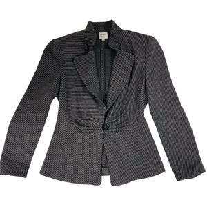 May include: A gray and black striped blazer with a single-button closure. The blazer has a notched lapel and long sleeves. The label "ARMANI" is visible on the collar.