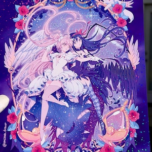 May include: A vibrant illustration featuring two anime-style characters within a decorative frame of roses and gold accents. One character has pink hair and white wings, the other has black hair and dark wings. The background is a starry night sky.