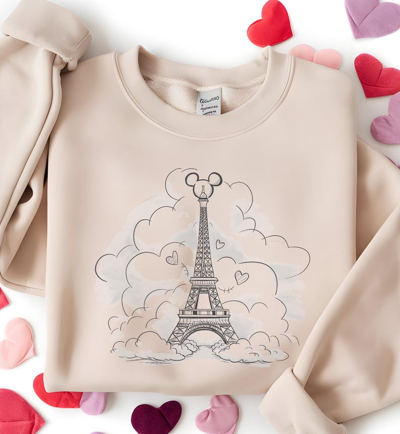 Disney meets Paris in this magical tee featuring the Eiffel Tower with a classic Mickey Mouse head perched on top. Perfect for Disneyland Paris vacations, this design blends iconic French landmarks with beloved Disney charm. Ideal for families, travel lovers, or Disney fans making memories in the City of Light. A stylish and fun shirt for park visits, photo ops, or post-trip souvenirs.