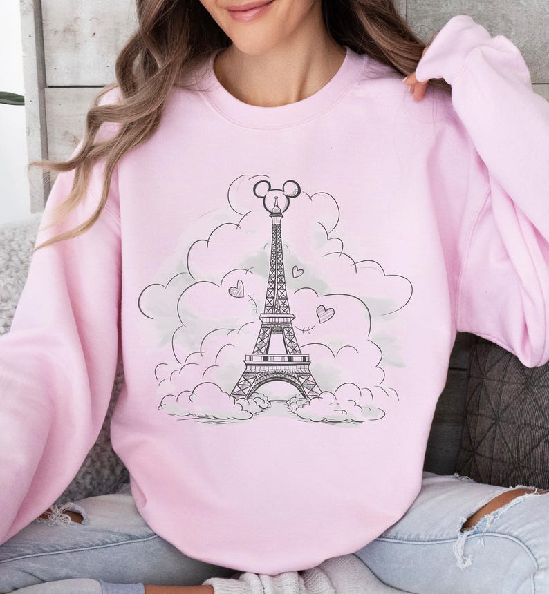Disney meets Paris in this magical tee featuring the Eiffel Tower with a classic Mickey Mouse head perched on top. Perfect for Disneyland Paris vacations, this design blends iconic French landmarks with beloved Disney charm. Ideal for families, travel lovers, or Disney fans making memories in the City of Light. A stylish and fun shirt for park visits, photo ops, or post-trip souvenirs.