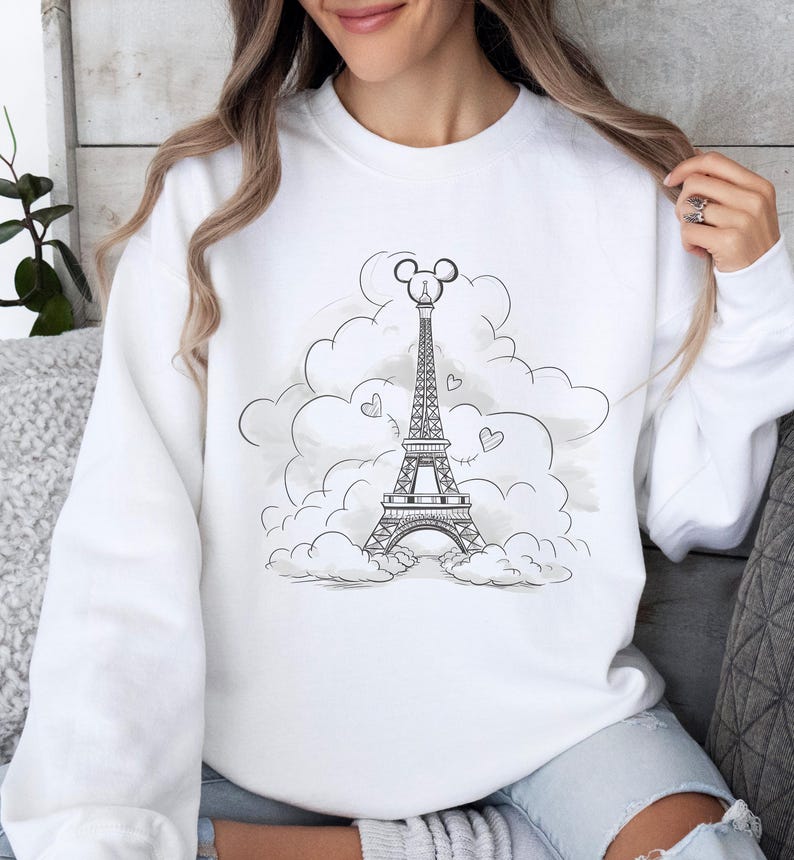 Disney meets Paris in this magical tee featuring the Eiffel Tower with a classic Mickey Mouse head perched on top. Perfect for Disneyland Paris vacations, this design blends iconic French landmarks with beloved Disney charm. Ideal for families, travel lovers, or Disney fans making memories in the City of Light. A stylish and fun shirt for park visits, photo ops, or post-trip souvenirs.