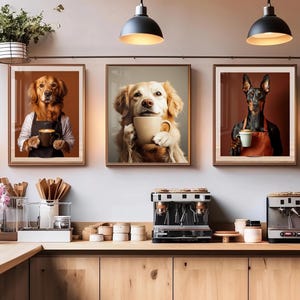 May include: Three framed dog portraits hang on a wall above a wooden counter. Each dog is holding a coffee cup. The first is a golden retriever wearing an apron. The second is a golden retriever holding a cup. The third is a Doberman wearing an apron.