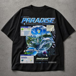 May include: Black t-shirt with a graphic design featuring the word "PARADISE" and a futuristic landscape inside a bubble. The design includes a dolphin, text that reads "touch grass", and Japanese text.