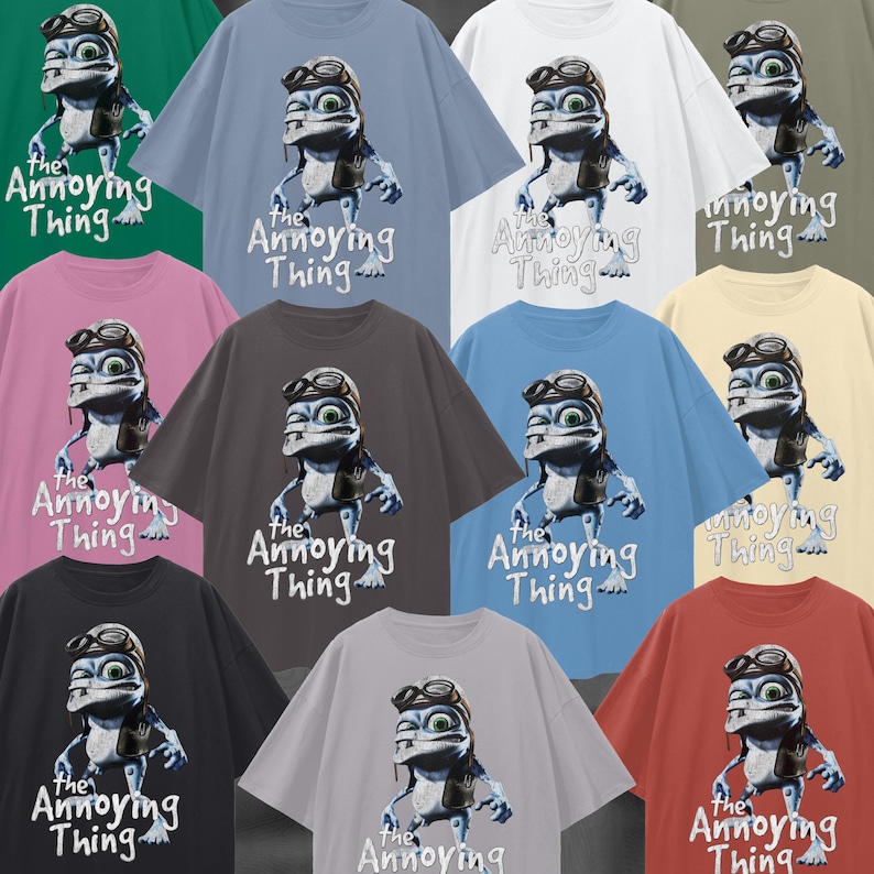 May include: A collection of oversized t-shirts in various colors, each featuring a cartoon frog character wearing goggles and a leather jacket. The text "the Annoying Thing" is printed below the frog.