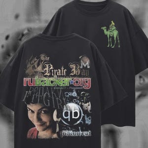May include: Two black t-shirts. One features a graphic with a woman's face, text including "The Pirate Bay" and "rutracker.org". The other shirt has a green camel and rider graphic. Both shirts are oversized.