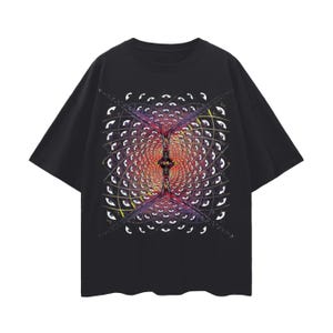 May include: Black t-shirt featuring a vibrant, geometric design with a central, symmetrical pattern in red, yellow, and purple. The design includes multiple eye-like shapes arranged in a grid-like pattern, creating a visually striking effect.