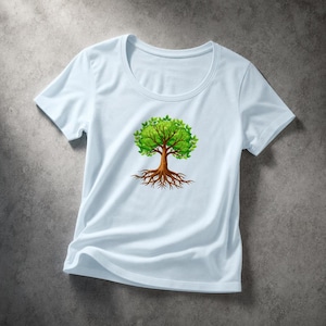 May include: A light blue t-shirt featuring a graphic of a tree with green leaves and brown roots. The tree design is centered on the shirt. The shirt has a round neckline and short sleeves.