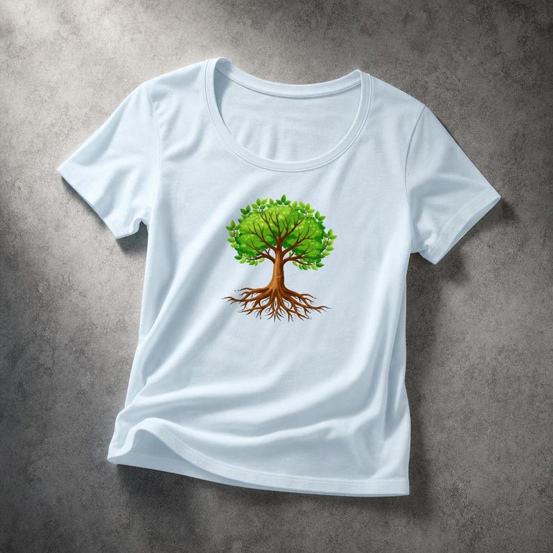 May include: A light blue t-shirt featuring a graphic of a tree with green leaves and brown roots. The tree design is centered on the shirt. The shirt has a round neckline and short sleeves.