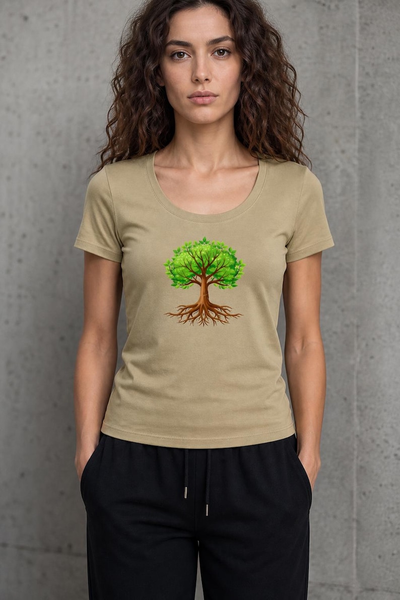 May include: A tan scoop-neck t-shirt featuring a vibrant tree graphic. The tree has a brown trunk, roots, and bright green leaves. The shirt is a neutral color and has short sleeves.