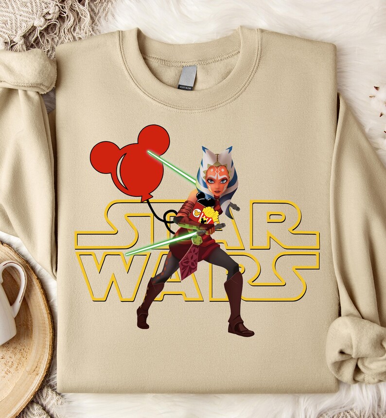 Star Wars shirt featuring fan-favorite characters like Darth Vader, Baby Yoda, Chewbacca, and Han Solo with fun Mickey head accents. This soft, unisex tee or sweatshirt is perfect for Disney trips, Star Wars Day, or matching family outfits. A playful mix of galaxy and Disney magic, ideal for park hopping, themed parties, or gifting to fans of the Mandalorian and the whole Star Wars crew.