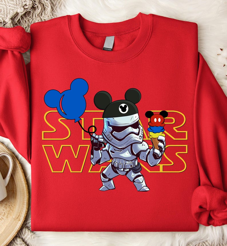 Star Wars shirt featuring fan-favorite characters like Darth Vader, Baby Yoda, Chewbacca, and Han Solo with fun Mickey head accents. This soft, unisex tee or sweatshirt is perfect for Disney trips, Star Wars Day, or matching family outfits. A playful mix of galaxy and Disney magic, ideal for park hopping, themed parties, or gifting to fans of the Mandalorian and the whole Star Wars crew.