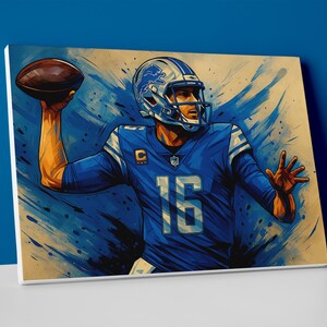May include: Canvas art print depicting a football player in a blue uniform, number 16, throwing a brown football. The player wears a helmet with a silver and blue design. The background features blue brushstrokes.