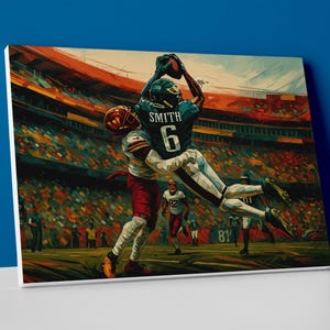 May include: A canvas print of an American football game in action. The artwork depicts a player in a green jersey with the number 6 leaping to catch a football, while another player in a red uniform attempts to block. The background shows a stadium filled with spectators.