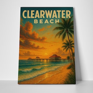 May include: A framed print of Clearwater Beach at sunset. The artwork features a pier extending into the ocean, palm trees, and the text "Clearwater Beach" in a vintage style.