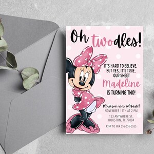 May include: A pink Minnie Mouse birthday invitation with the text "Oh twodles!" and "Madeline is turning two!" The invitation features a cartoon illustration of Minnie Mouse in a pink polka dot dress and bow. An envelope is in the background.