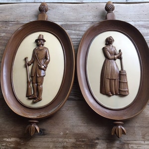 6072 Mid Century SYROCO Pilgrim/Pioneer Oval Wall Hanging Plaques Made In USA Man with musket, woman with butter churn