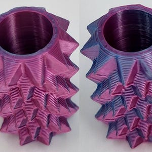May include: Six cylindrical objects with a spiky, geometric exterior texture. Each piece features a color-shifting finish that transitions between shades of metallic purple, magenta, and blue. The items have a hollow, open-top circular opening.