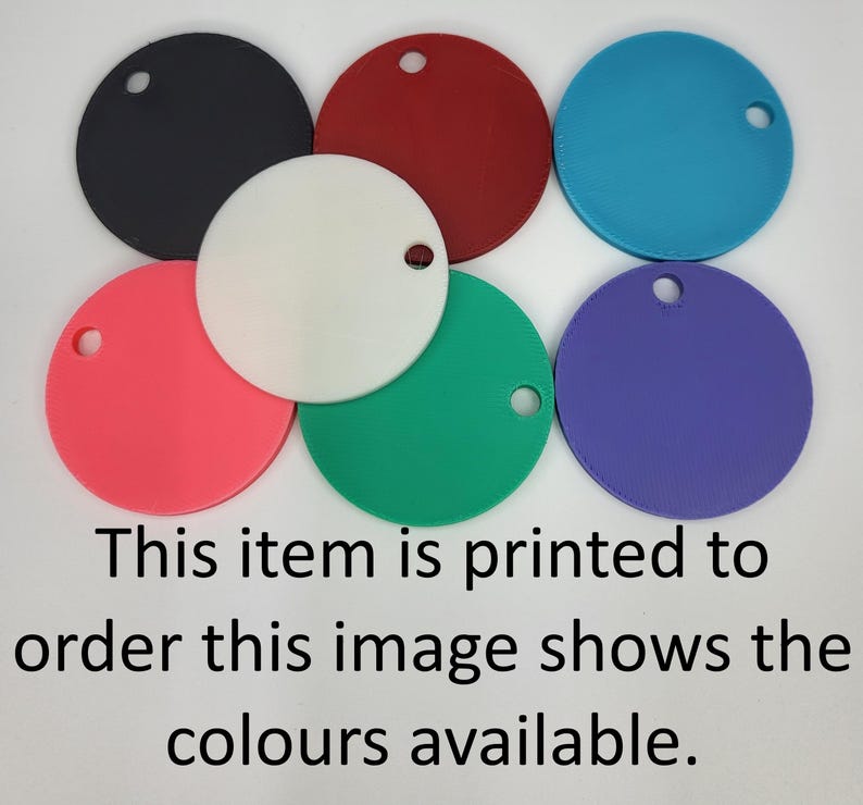 May include: Six circular tags in black, red, blue, white, pink, green, and purple, each featuring a single hole near the edge. The text reads: This item is printed to order this image shows the colours available.
