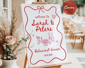 May include: A white sign on an easel with red text and illustrations. The sign reads "welcome to Sarah & Peters Rehearsal dinner 09.25.2030". A red circle with the word "Canva" is in the upper right corner.