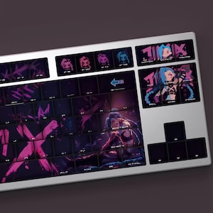 May include: A silver mechanical keyboard with custom keycaps featuring a purple and pink graphic design. The keycaps display artwork of a character with blue hair. The keyboard has a variety of function keys and a number pad.
