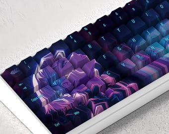 May include: A white mechanical keyboard with a custom keycap set featuring a colorful abstract design in shades of purple, blue, and pink. The keyboard has a standard layout with keys labeled with letters, numbers, and symbols.