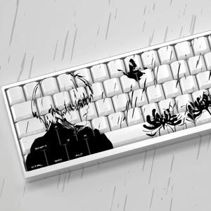May include: White mechanical keyboard with black anime-style graphics. The design features a character profile and floral accents. The keyboard has white keycaps and a white frame.