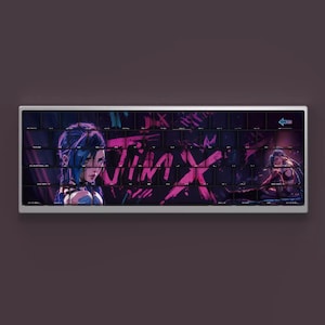 May include: A rectangular keyboard with a custom design featuring artwork of a character with blue hair and the word "JINX" in pink and white. The keyboard has a silver frame and black keys.