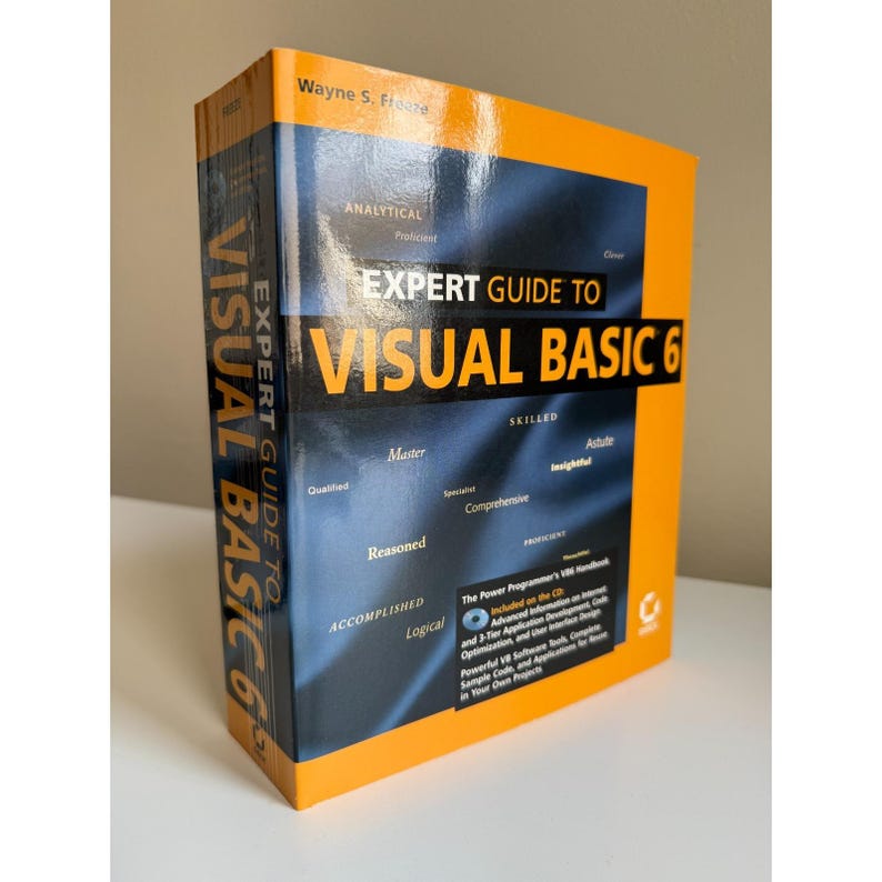 Może przedstawiać: Książka w twardej oprawie zatytułowana "Expert Guide to Visual Basic 6" autorstwa Wayne'a S. Freeze. Okładka jest gł&oacute;wnie pomarańczowa i granatowa, z tytułem dużymi, pogrubionymi literami. Okładka książki zawiera słowa opisowe, takie jak "Analityczny" i "Wykwalifikowany".