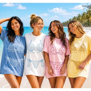 May include: Four short-sleeve t-shirts in blue, white, pink, and yellow, each featuring a graphic print of a bikini set with the text Anna's Bach Miami 2024. The blue shirt has a net pattern, white has a shell design, pink has starfish, and yellow has leopard print.