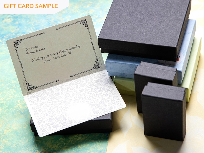 May include: A gift card sample with a black and white patterned border. The card has a message that reads "To Anna From: Jessica Wishing you a very Happy Birthday. to my Aries sister".