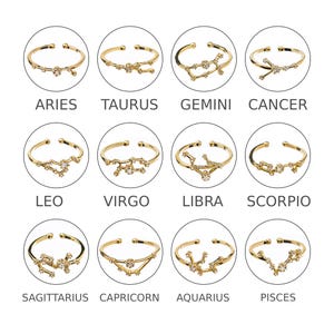 May include: Twelve gold rings with a constellation design and clear crystals. Each ring features a different zodiac sign: Aries, Taurus, Gemini, Cancer, Leo, Virgo, Libra, Scorpio, Sagittarius, Capricorn, Aquarius, and Pisces.