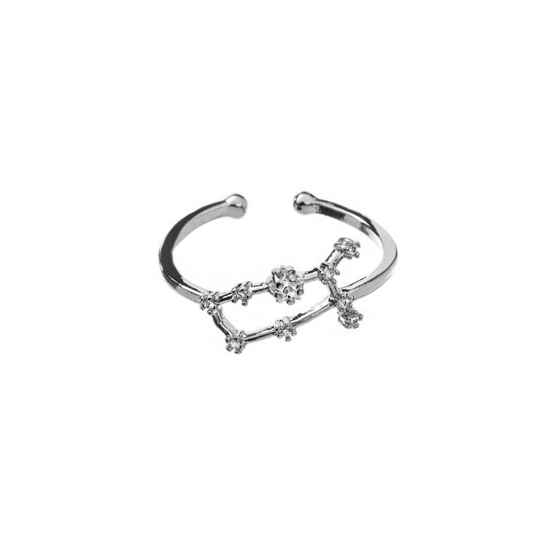 May include: Silver ring with a constellation design featuring small clear rhinestones. The constellation is Gemini.