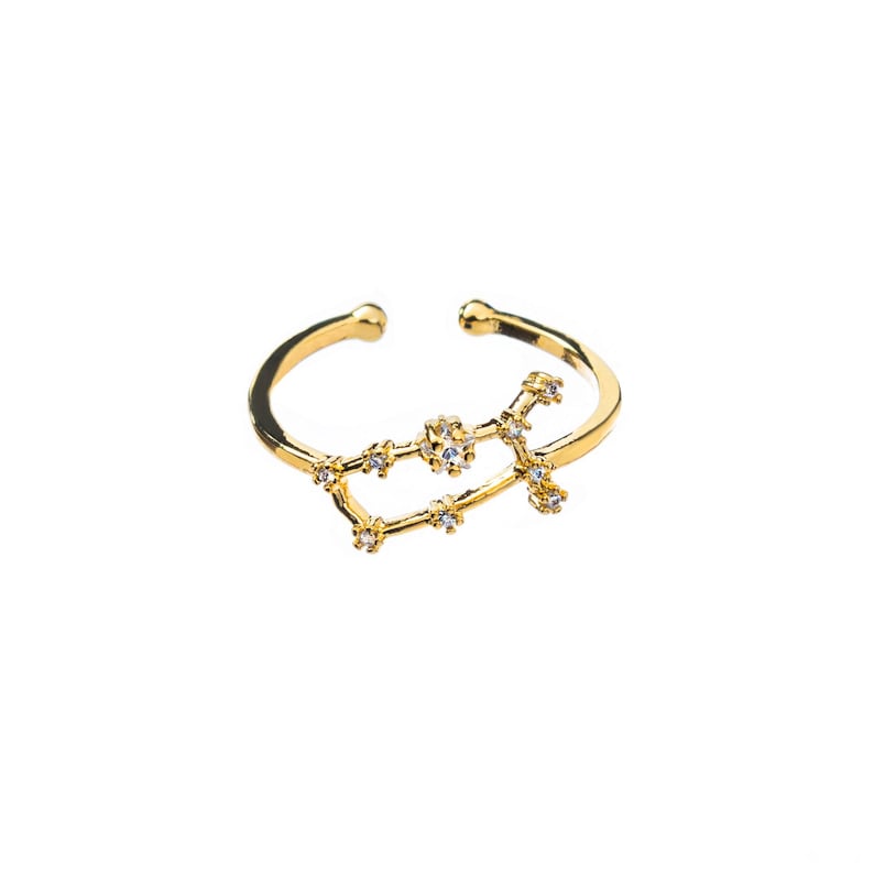 May include: A gold adjustable ring with a constellation design featuring small clear rhinestones.