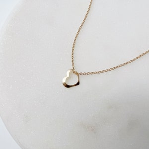 a minimalist gold heart necklace