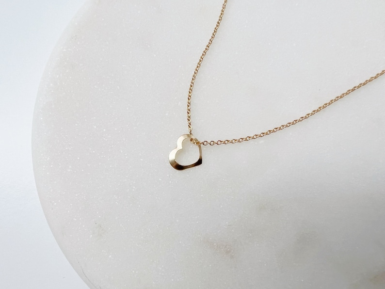 a minimalist gold heart necklace