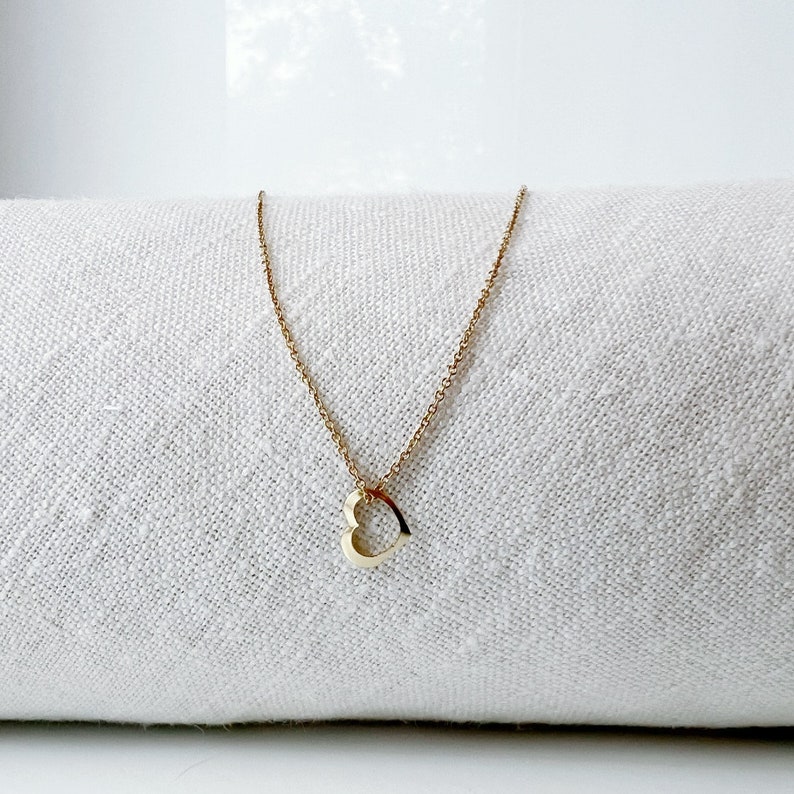 a minimalist gold heart necklace