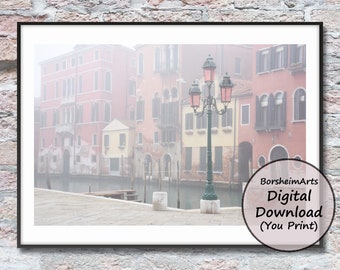 May include: A foggy canal scene in Venice, Italy, with colorful buildings and a vintage street lamp. The buildings are reflected in the water, and the fog creates a dreamy atmosphere.