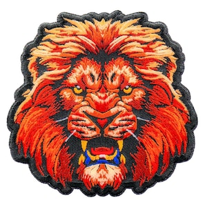 May include: A close-up of an embroidered lion's head patch. The lion has a fierce expression with its mouth open and teeth showing. The lion's mane is a bright orange color, and the background is black.