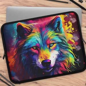 May include: A laptop sleeve featuring a vibrant, colorful wolf illustration. The artwork showcases a wolf's face with a rainbow of hues, including blues, yellows, and pinks, set against a dark background. The sleeve has a black border and a zipper closure.