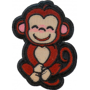 May include: Embroidered patch of a smiling monkey in red, black, and tan. The monkey is sitting with its legs crossed, and has pink ears and a smiling face. The patch has a black border and is suitable for clothing or accessories.