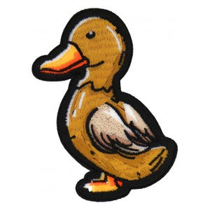 May include: Embroidered patch featuring a cartoon duck with a yellow body, orange beak and feet, and a black outline. The duck is in a standing position, with a friendly expression. The patch is likely for clothing or accessories.
